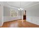 Dining room with hardwood flooring, wainscotting, and view into the kitchen at 912 Sethcreek Dr, Fuquay Varina, NC 27526