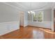 Bright dining room featuring hardwood flooring, wainscotting, and tray ceilings at 912 Sethcreek Dr, Fuquay Varina, NC 27526