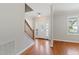 Bright foyer with hardwood floors, a staircase, a white front door, and a view to the front yard at 912 Sethcreek Dr, Fuquay Varina, NC 27526