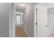 Neutral hallway with carpet floor and white trim, leading to bedrooms and bathrooms at 912 Sethcreek Dr, Fuquay Varina, NC 27526