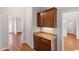 Hallway featuring hardwood flooring, storage cabinets and access to multiple rooms at 912 Sethcreek Dr, Fuquay Varina, NC 27526