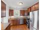 Charming kitchen with stainless steel appliances, wooden cabinetry and hardwood flooring at 912 Sethcreek Dr, Fuquay Varina, NC 27526