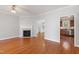 Spacious living room features hardwood floors, fireplace, ceiling fan, and an open doorway to the kitchen at 912 Sethcreek Dr, Fuquay Varina, NC 27526