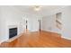 Large living room with hardwood flooring, a fireplace, and doorways leading to other rooms in the house at 912 Sethcreek Dr, Fuquay Varina, NC 27526