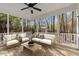 Inviting screened porch with comfortable seating and a view of the wooded backyard at 912 Sethcreek Dr, Fuquay Varina, NC 27526