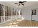 View of a screened porch with wood flooring and ceiling fan overlooking a wooded area at 912 Sethcreek Dr, Fuquay Varina, NC 27526