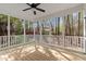 Sun-drenched screened porch with wood floors and forest views provides serene outdoor space at 912 Sethcreek Dr, Fuquay Varina, NC 27526