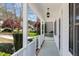 White porch with an outdoor light fixture and a view of the neighborhood in the background at 912 Sethcreek Dr, Fuquay Varina, NC 27526