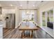 Cozy dining area adjacent to the kitchen with large windows and modern chandelier at 929 Thimbleweed Way, Wake Forest, NC 27587
