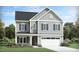 Charming two-story home featuring a two-car garage, landscaped front yard, and stylish board and batten siding at 929 Thimbleweed Way, Wake Forest, NC 27587