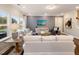 Well-lit living room featuring hardwood floors, modern decor, and large windows at 929 Thimbleweed Way, Wake Forest, NC 27587