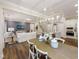 Open-concept living space featuring modern decor, hardwood floors, and seamless integration with the kitchen at 929 Thimbleweed Way, Wake Forest, NC 27587