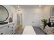 Bright bedroom featuring a decorative mirror, dresser, and a comfortable bed with stylish pillows at 933 Thimbleweed Way, Wake Forest, NC 27587
