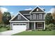 Charming two-story home features a gray exterior, a white garage door and a well-manicured lawn at 933 Thimbleweed Way, Wake Forest, NC 27587