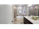 Elegant bathroom with a separate shower and tub, dual sinks, dark cabinets, and tile flooring at 937 Thimbleweed Way, Wake Forest, NC 27587