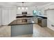 Bright kitchen with an island, stainless steel appliances and black countertops at 100 Ampad Ct, Cary, NC 27513