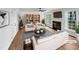 Bright, virtually staged living room with a fireplace, large windows, and stylish black and white decor at 100 Ampad Ct, Cary, NC 27513