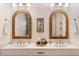 Bright bathroom with double sinks, granite countertops and stylish mirrors at 1008 North St, Durham, NC 27701
