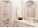 Bathroom featuring a shower/tub combo, white cabinets and a stylish gold faucet and mirror at 1008 North St, Durham, NC 27701