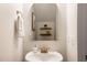 Close up of sink in bathroom featuring an arched mirror and modern gold faucet at 1008 North St, Durham, NC 27701