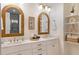 Bright bathroom with double sinks, granite countertops and stylish mirrors at 1008 North St, Durham, NC 27701