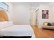A bedroom with hardwood floors, a large headboard, and a small seating area at 1008 North St, Durham, NC 27701
