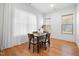 Bright dining room with hardwood floors, sheer curtains, and a square table with four chairs at 1008 North St, Durham, NC 27701