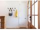 Entryway with wood floors, coat rack, and a glimpse of the front door with sidelight windows at 1008 North St, Durham, NC 27701