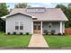 Charming home with a well-maintained front yard, covered porch, and natural wood front door at 1008 North St, Durham, NC 27701