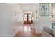 Hallway with wood floors and a pair of French doors at the end at 1008 North St, Durham, NC 27701