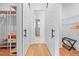 Bright hallway with white barn doors, wood floors, and closet organizers at 1008 North St, Durham, NC 27701