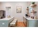Bright kitchen with light green cabinets, white countertops, and an island with seating at 1008 North St, Durham, NC 27701
