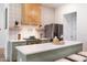 Charming kitchen featuring a gas range, wooden hood, and an island with seating at 1008 North St, Durham, NC 27701