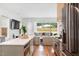 Open kitchen with a view to a backyard living area and a large island with seating at 1008 North St, Durham, NC 27701
