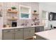 Stylish kitchen featuring stone countertops, tile backsplash, floating shelves, and stainless appliances at 1008 North St, Durham, NC 27701