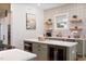 A kitchen with stainless steel appliances, an island with a wine fridge, and a microwave at 1008 North St, Durham, NC 27701