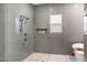 Modern bathroom shower with gray subway tile, bronze fixtures and storage niche at 1008 North St, Durham, NC 27701