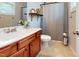 Cozy bathroom features a cherry vanity with a white sink, a framed mirror, and a shower with a curtain at 11 Balboa Pkwy, Clayton, NC 27520