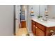 Bathroom features a vanity with storage, a framed mirror, and tile flooring at 11 Balboa Pkwy, Clayton, NC 27520