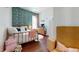 Charming bedroom with hardwood floors, a brass bed frame, patterned wallpaper, and a window at 11 Balboa Pkwy, Clayton, NC 27520