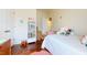 Bright bedroom with hardwood floors, a white bed, and a bookshelf filled with colorful books at 11 Balboa Pkwy, Clayton, NC 27520