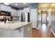 Modern kitchen with white cabinets, stainless steel appliances, and a large island with a granite countertop at 11 Balboa Pkwy, Clayton, NC 27520