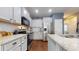 Bright kitchen with white cabinets, stainless steel appliances, granite countertops, and hardwood floors at 11 Balboa Pkwy, Clayton, NC 27520