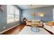 Relaxing living room with hardwood floors, large windows, and a comfortable sofa at 11 Balboa Pkwy, Clayton, NC 27520