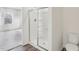 Modern bathroom design featuring a glass-enclosed shower and an adjacent room with large windows at 112 Oat Grain Ct, Clayton, NC 27520