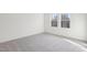 Light-filled bedroom has neutral color scheme, plush carpeting, and bright windows at 112 Oat Grain Ct, Clayton, NC 27520