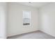 Bright bedroom with plush carpeting and a window providing natural light at 112 Oat Grain Ct, Clayton, NC 27520