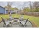 Charming backyard features a stone fire pit and Adirondack chairs, perfect for outdoor gatherings at 1120 N Roxboro St, Durham, NC 27701