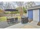 Outdoor area features dining set, grill, string lights, and firepit, perfect for entertaining at 1120 N Roxboro St, Durham, NC 27701