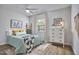Bright bedroom with a ceiling fan, decoratively styled furniture, and a large window at 1120 N Roxboro St, Durham, NC 27701